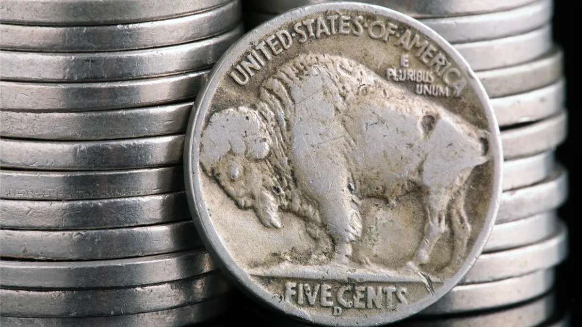A pile of 2005 Buffalo Nickels stacked, showing the bison design.