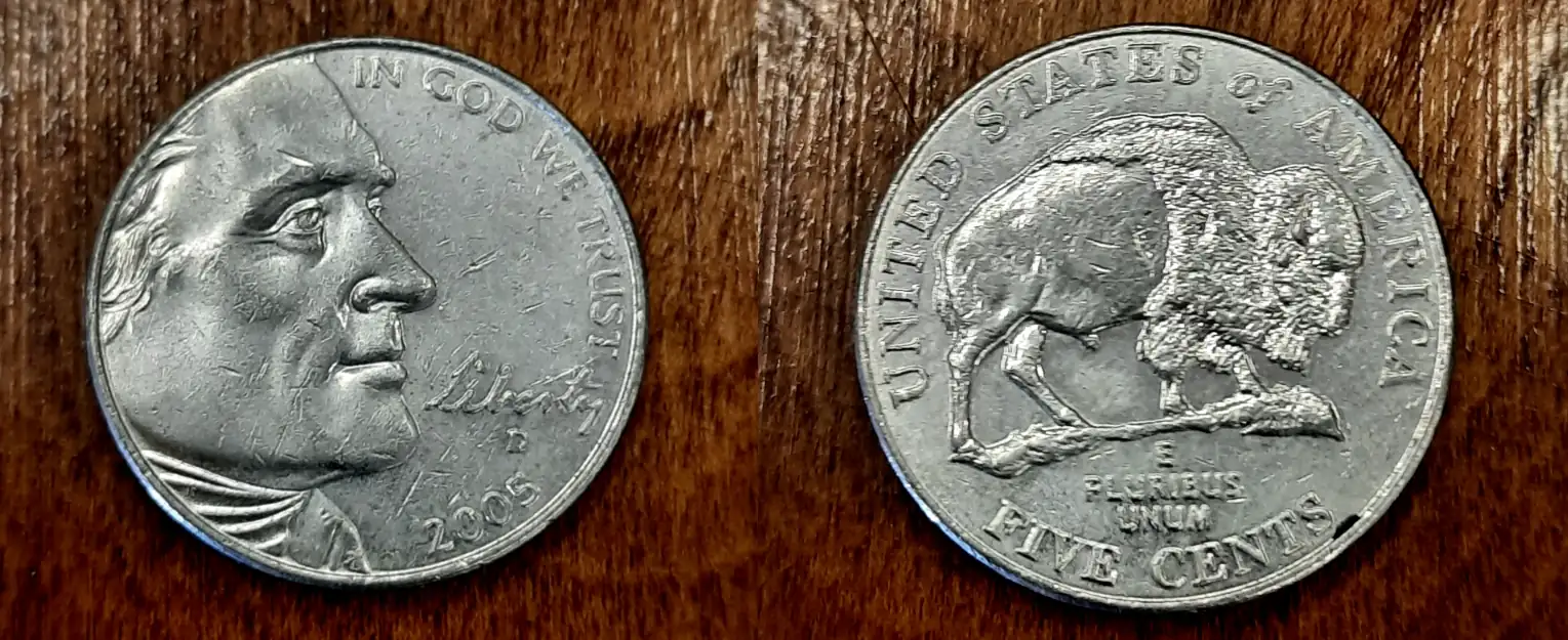 A picture of the 2005-D Buffalo nickel with a visible circular defect caused by a misaligned or missing clad layer.